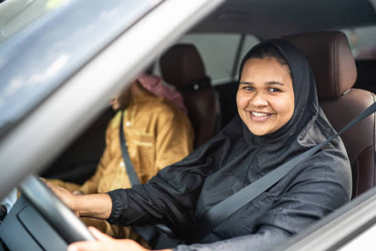 A female instructor teaching a woman to drive in Abbottabad