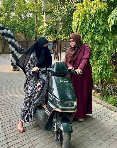 A female instructor teaching a woman to ride a scooty in Abbottabad